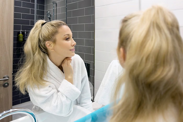 Woman assessing Botox results two weeks after the treatment