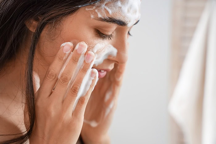 woman washing face after botox treatment