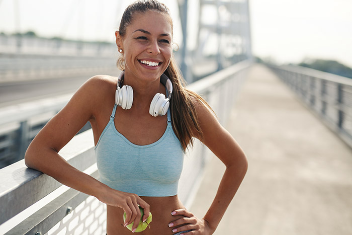 Woman post-run with glowing skin, illustrating minimal downtime after Profhilo Structura treatment.