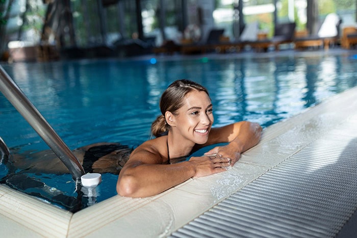 woman enjoying swimming after botox treatment