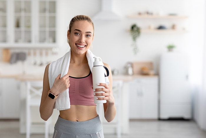 Woman engaging in exercise, representing a return to physical activity following the recommended rest period after Profhilo treatment.